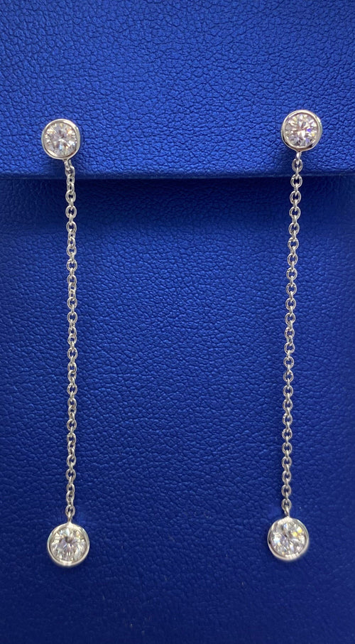 A pair of TEMPLATE by The DiamondLab lab-grown diamond drop earrings on a blue box.